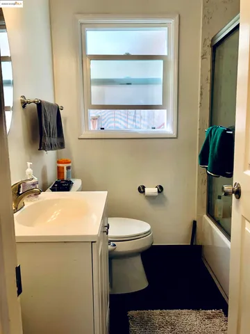 a bathroom with a toilet a sink and a mirror
