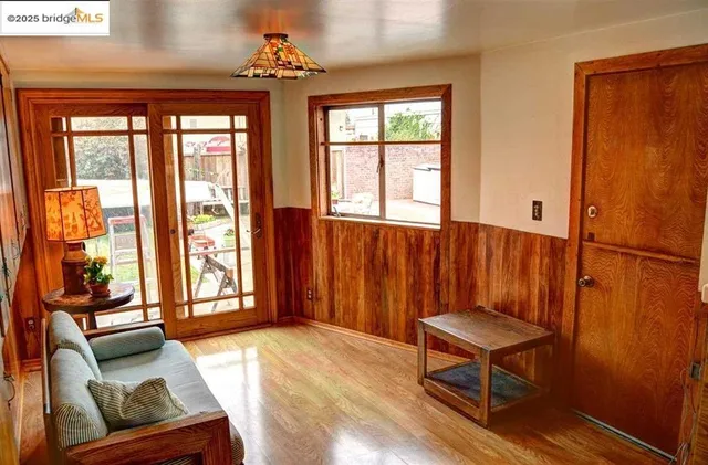 a view of staircase going to a house with wooden floor