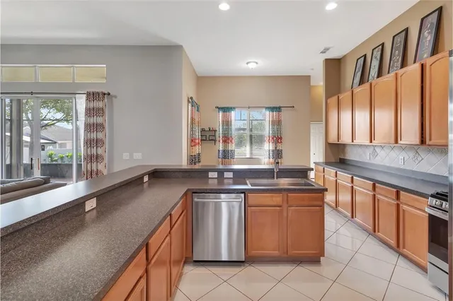 a kitchen with stainless steel appliances granite countertop a sink and stove