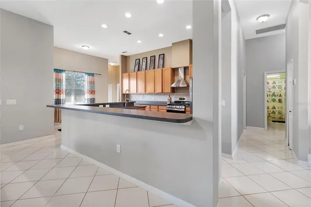 a kitchen with stainless steel appliances a refrigerator and a stove