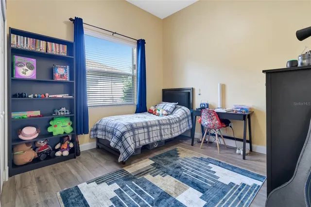 a bedroom with a bed and a table in it