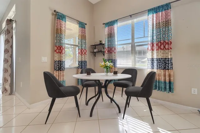 a dining room with furniture and window