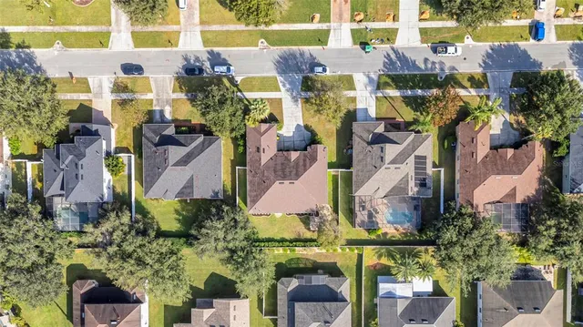 an aerial view of multiple houses with yard