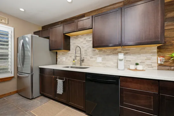 a kitchen with stainless steel appliances a sink cabinets and a counter top space