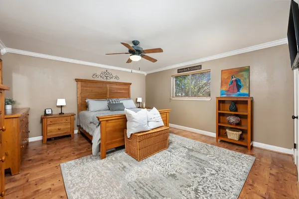a living room with furniture and wooden floor
