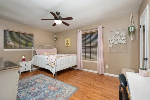 a bedroom with a bed and wooden floor