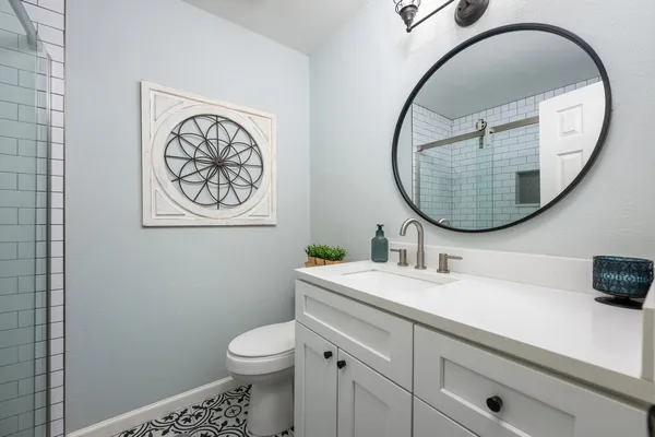 a bathroom with a toilet a sink and a mirror