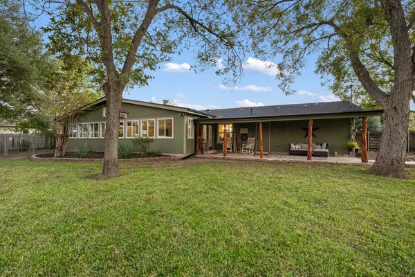 a view of a house with a backyard