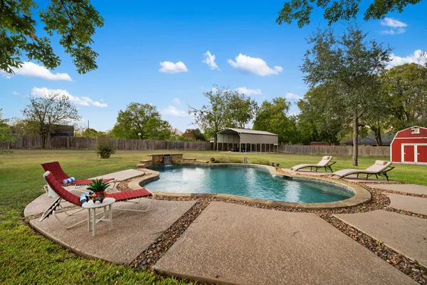 swimming pool view with a seating space