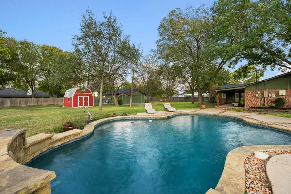a view of a swimming pool with a patio