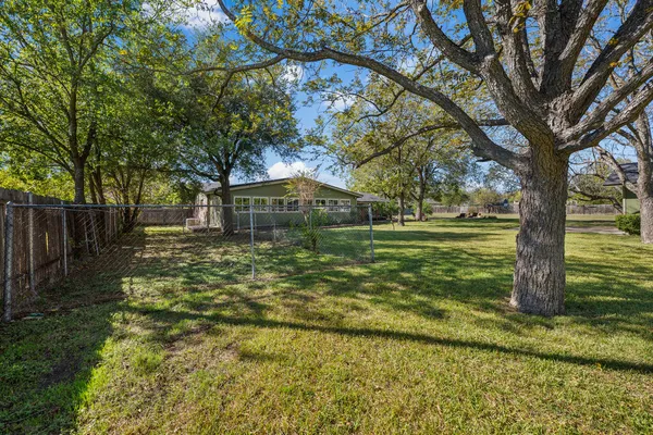 a backyard of a house with lots of green space