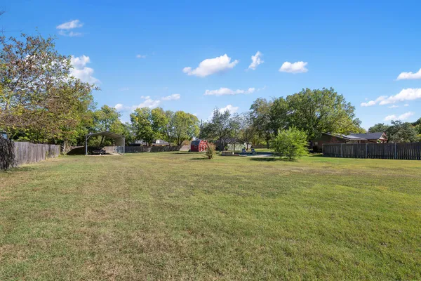 a view of outdoor space with garden and trees