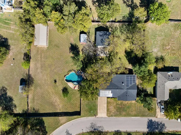 an aerial view of a house with a yard