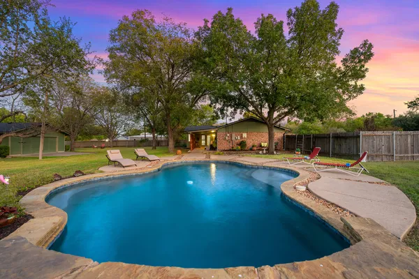 a view of a swimming pool with a patio