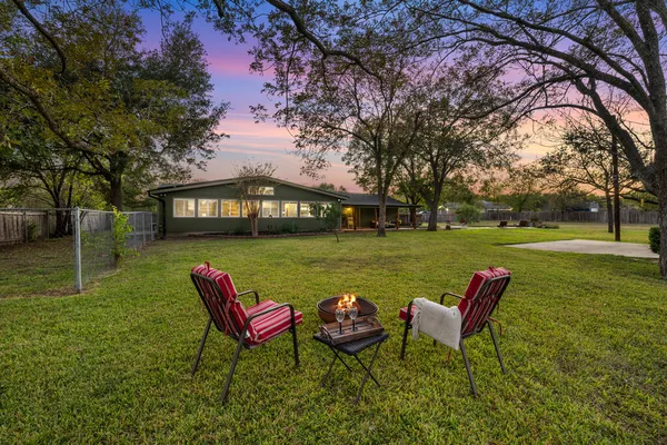 a view of a swimming pool with a patio and a yard