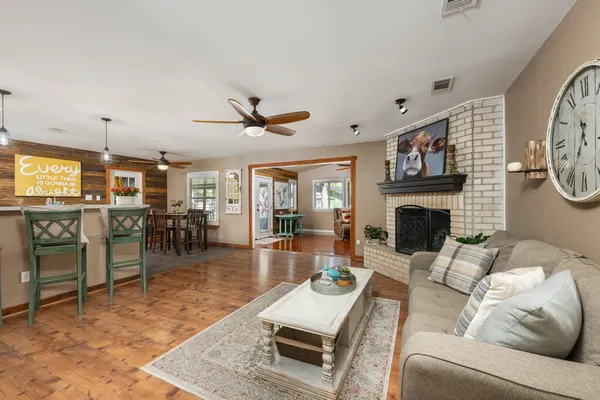 a living room with furniture a fireplace and a flat screen tv