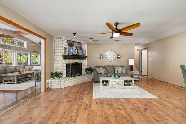 a living room with furniture a fireplace and a flat screen tv