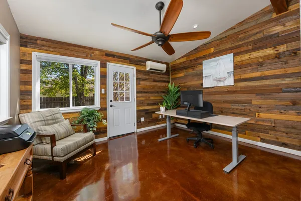 a living room with furniture a rug and a large window