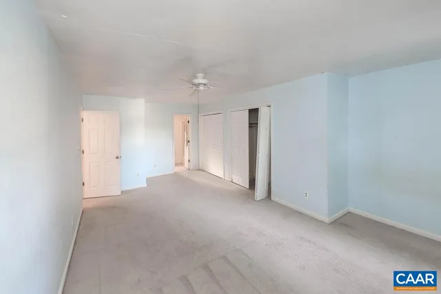 a view of a hallway with wooden floor and entryway
