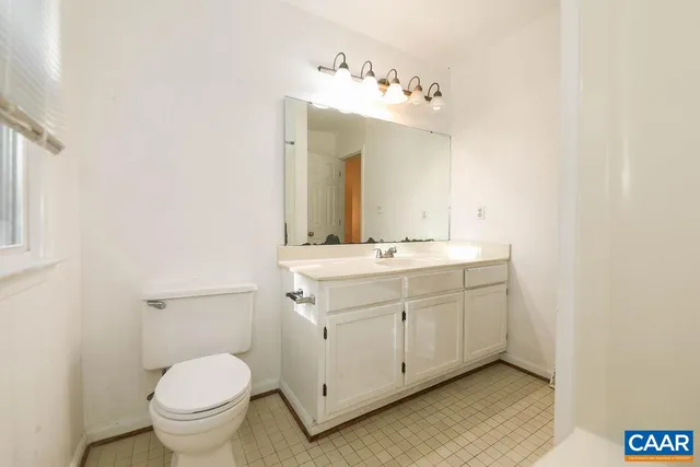 an empty room with window and closet