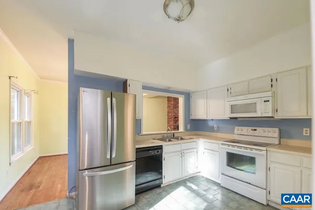 a kitchen with a refrigerator stove and sink