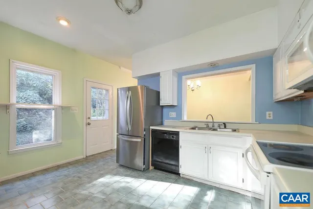 a kitchen that has a sink a stove and a refrigerator