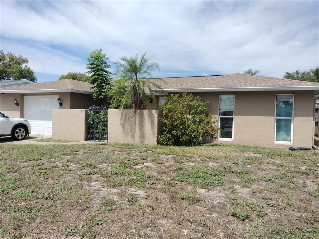 6811 Tierra Linda Street Port Richey, FL 34668 - Photo 1 of 1 a house with a yard and a garage