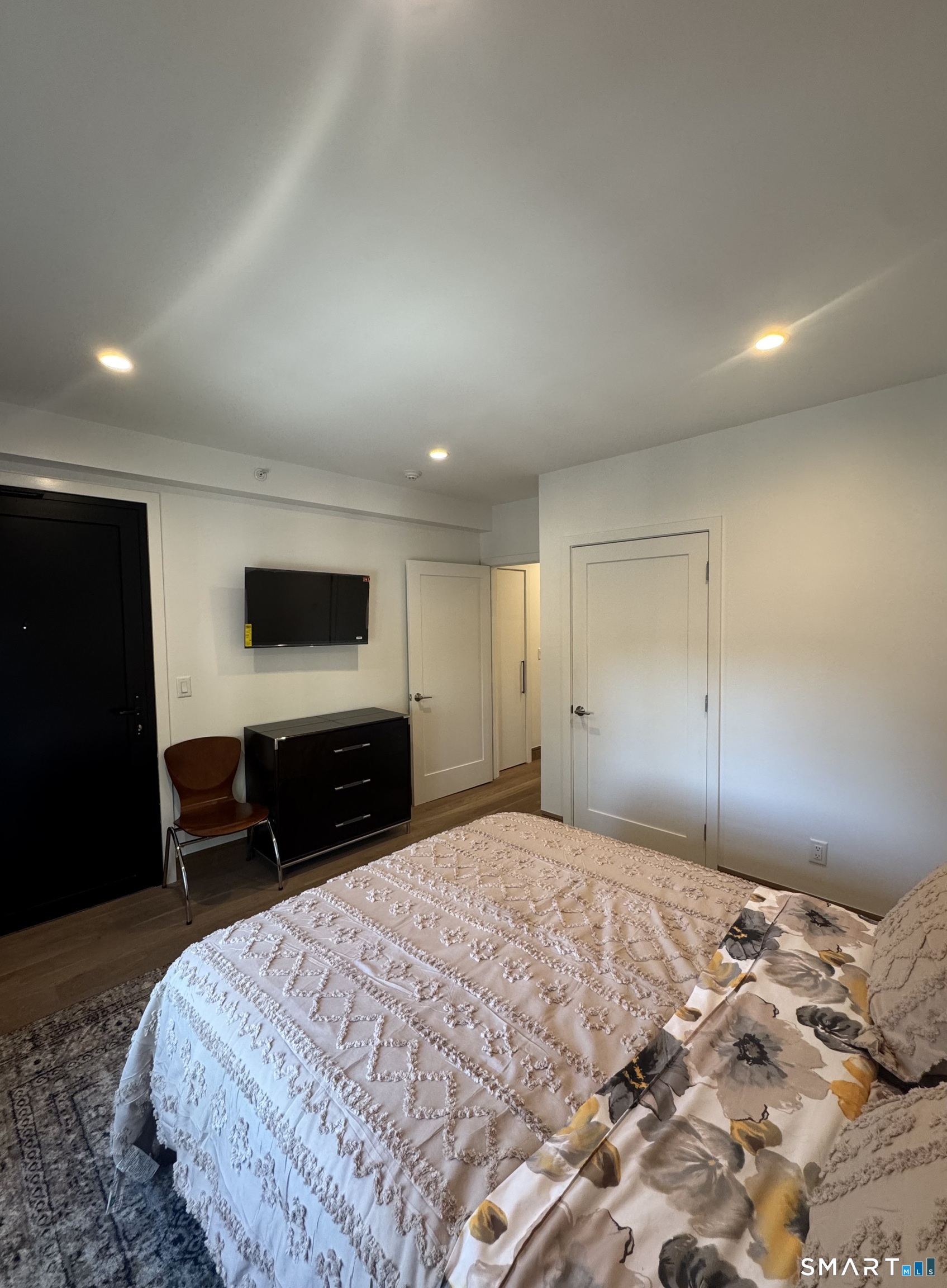 930 Cove Road, Unit 2 Stamford, CT 06902 - Photo 9 of 14 a bedroom with a bed and a flat screen tv