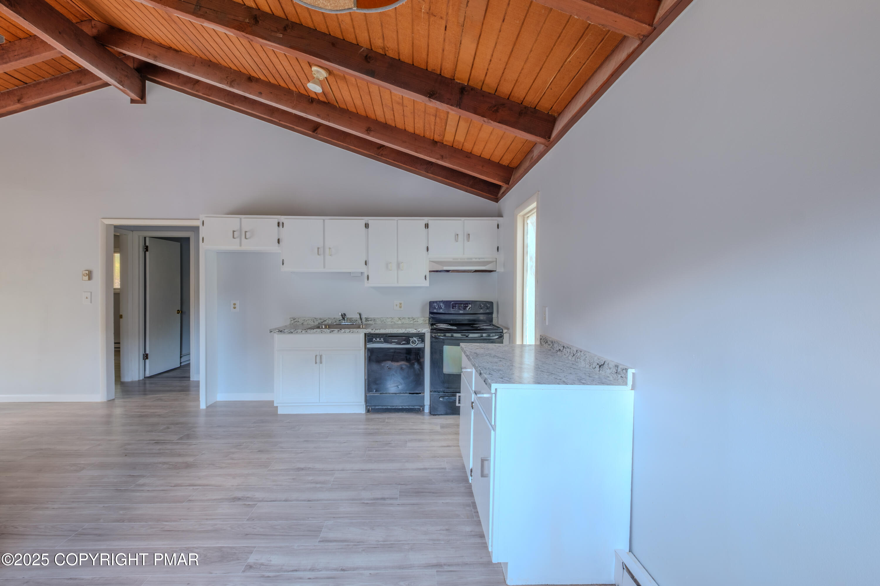 4774 Pine Ridge Drive West Bushkill, PA 18324 - Photo 19 of 36 a kitchen with a refrigerator and a stove top oven