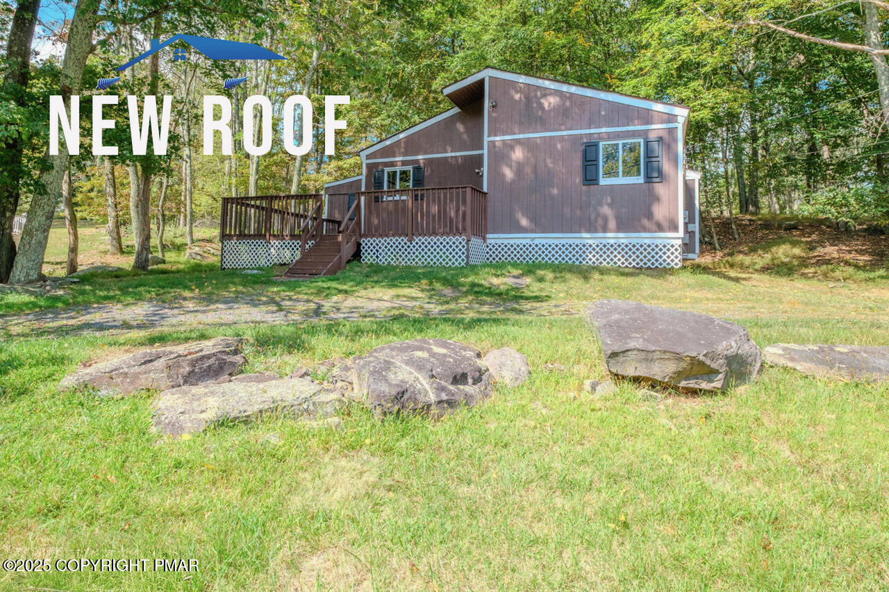 4774 Pine Ridge Drive West Bushkill, PA 18324 - Photo 2 of 36 a view of a house with backyard and a garden