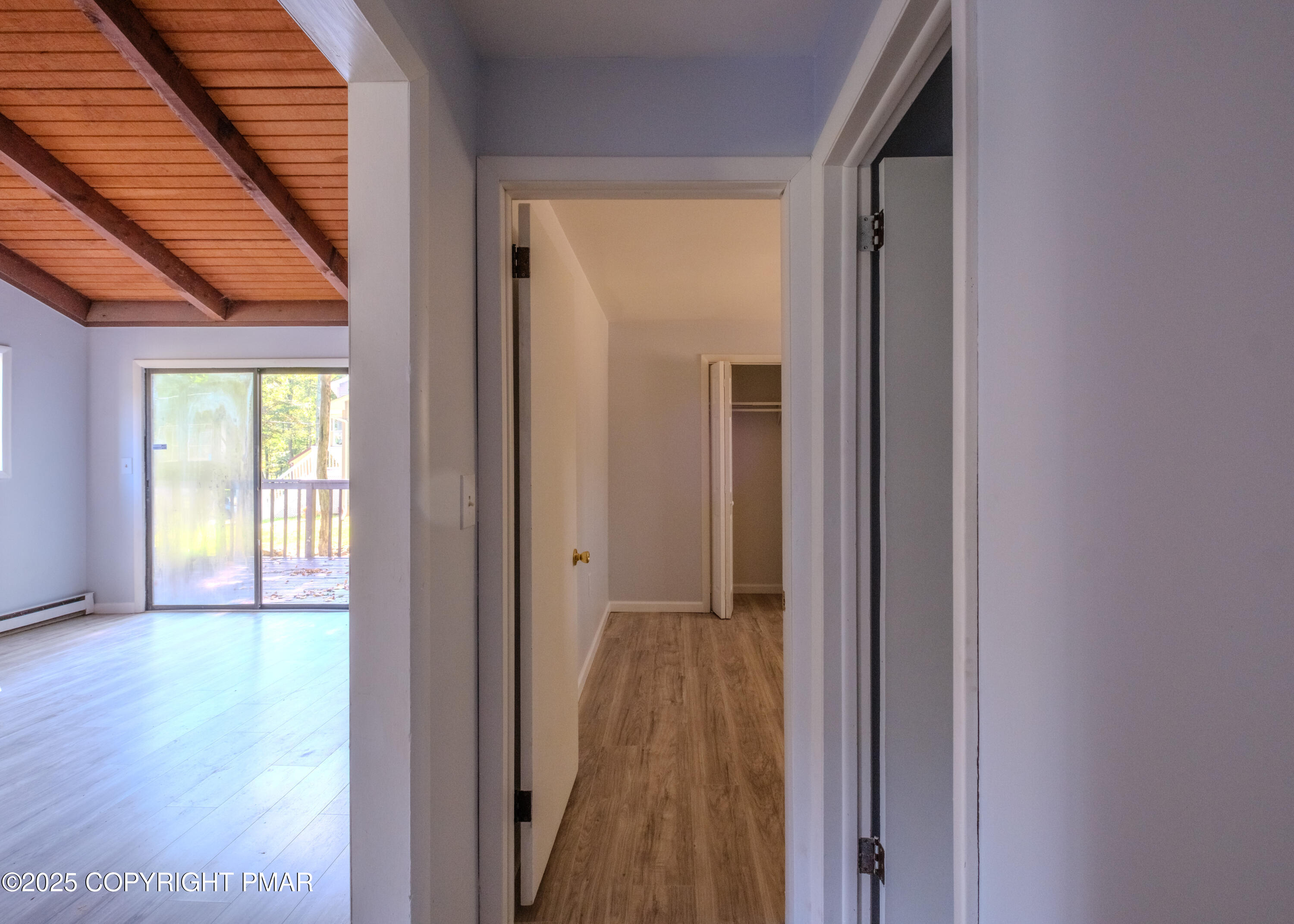 4774 Pine Ridge Drive West Bushkill, PA 18324 - Photo 23 of 36 a view of a hallway with wooden floor and a window