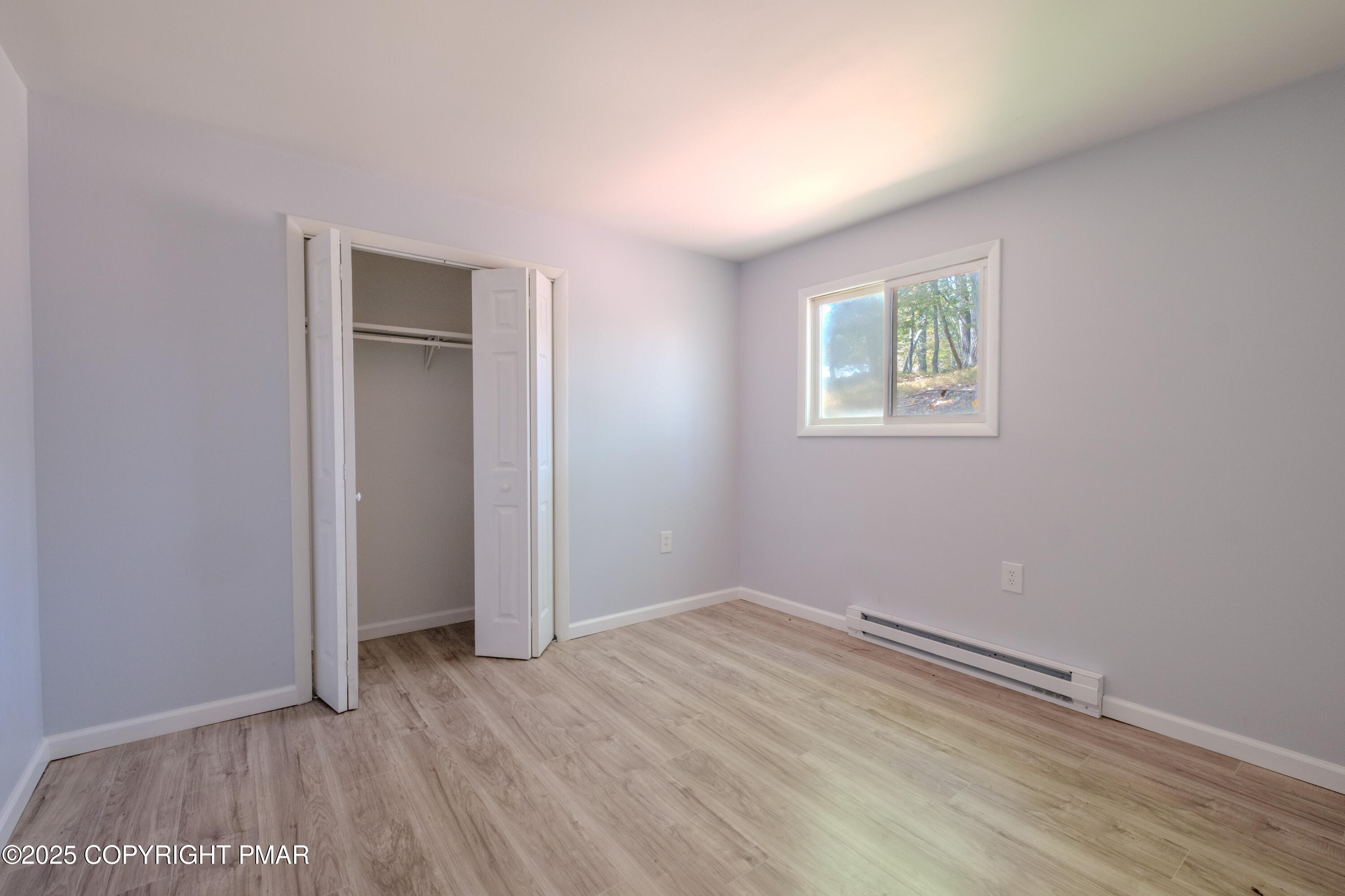 4774 Pine Ridge Drive West Bushkill, PA 18324 - Photo 24 of 36 an empty room with wooden floor and closet