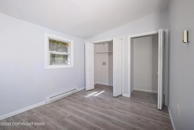 a view of entryway with window and wooden floor