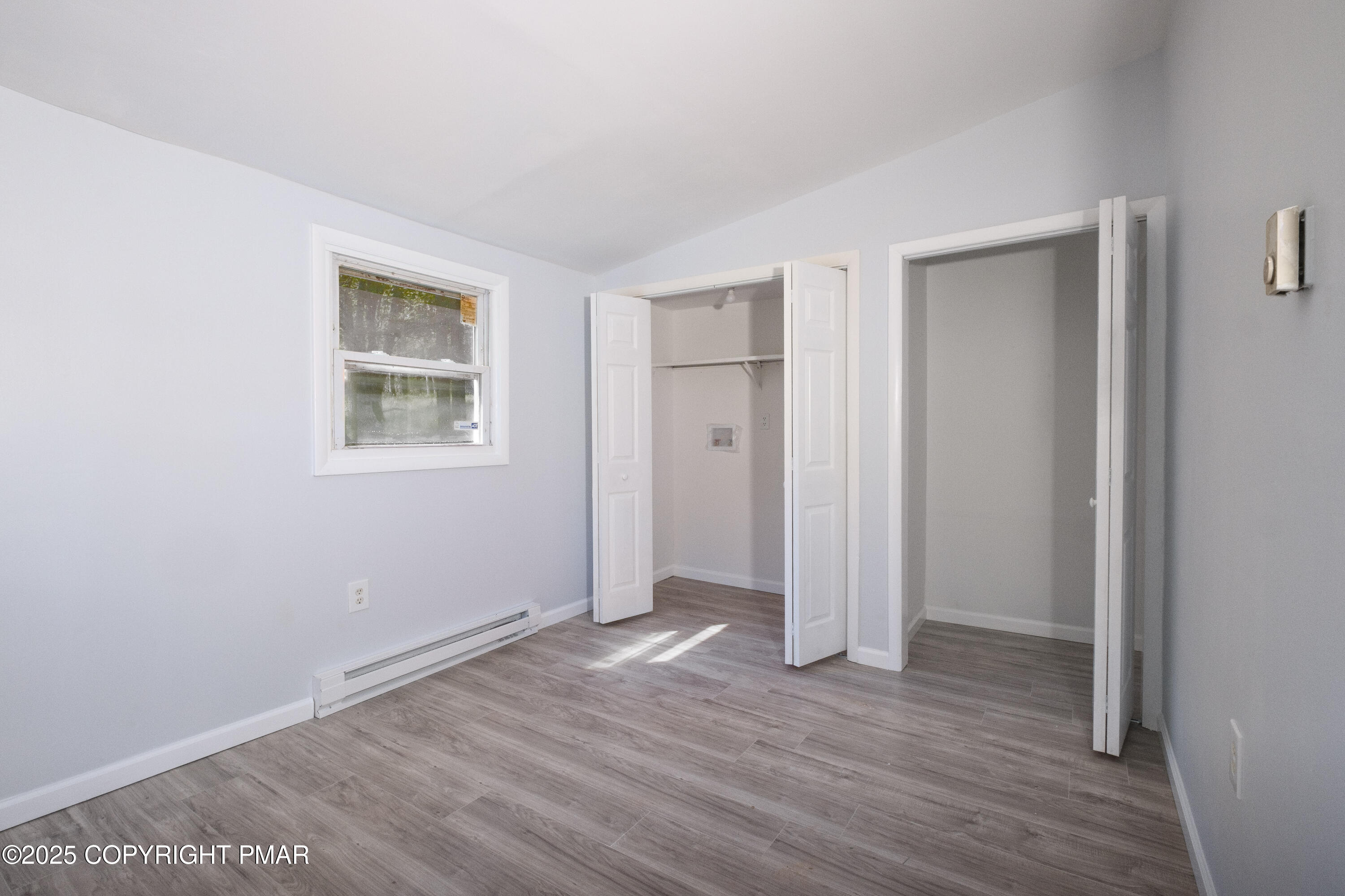 4774 Pine Ridge Drive West Bushkill, PA 18324 - Photo 26 of 36 an empty room with wooden floor and windows