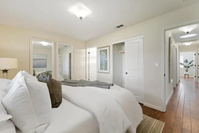 a spacious bedroom with a bed and a walk in closet