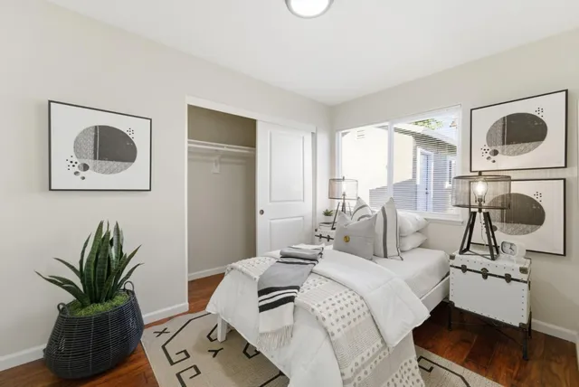 a bedroom with a bed and wooden floor