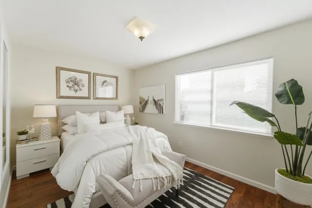 a bedroom with a bed and a window