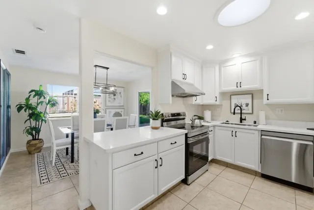 a kitchen with a sink counter top space appliances and cabinets