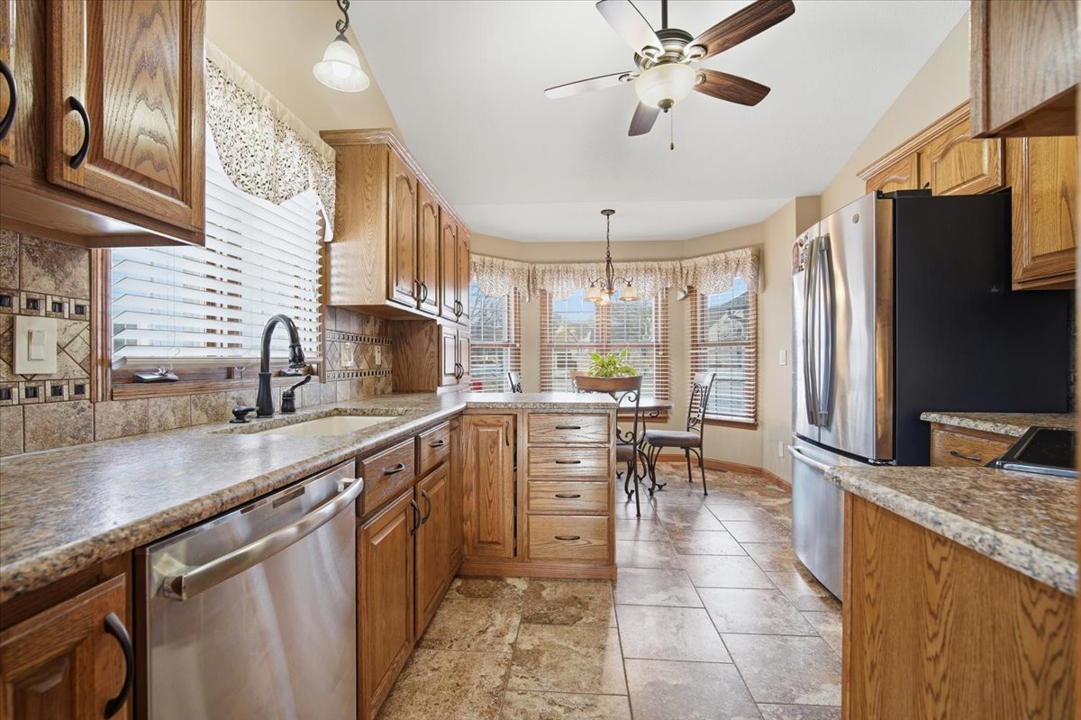 9 Spruce Court Bloomington, IL 61704 - Photo 11 of 42 a kitchen with stainless steel appliances granite countertop a sink a stove counter space and cabinets