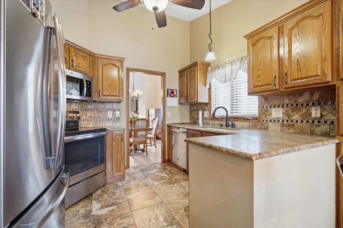 9 Spruce Court Bloomington, IL 61704 - Photo 12 of 42 a kitchen with stainless steel appliances granite countertop a sink stove and refrigerator