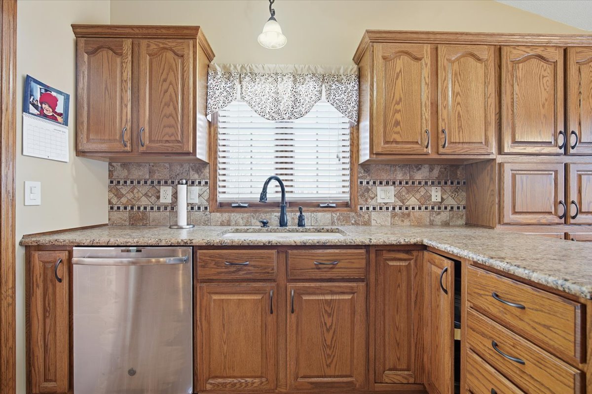 9 Spruce Court Bloomington, IL 61704 - Photo 14 of 42 a kitchen with granite countertop a sink stainless steel appliances and cabinets