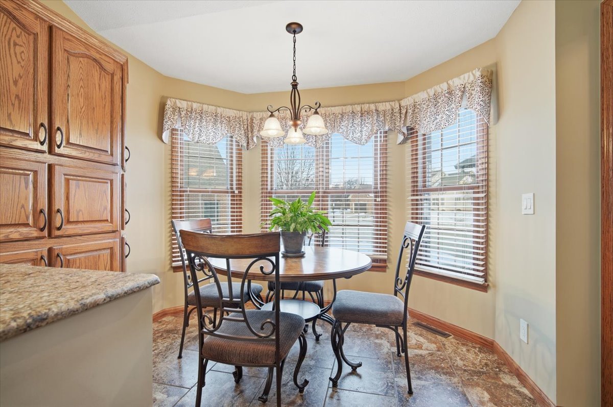9 Spruce Court Bloomington, IL 61704 - Photo 15 of 42 a dining room with furniture and window