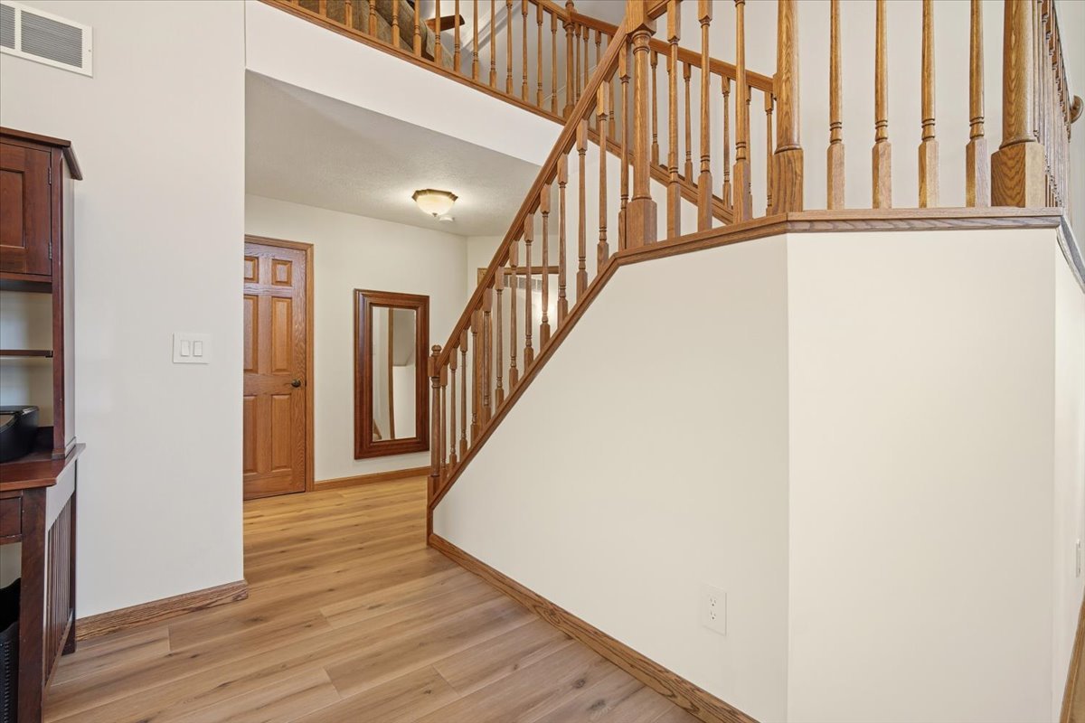 9 Spruce Court Bloomington, IL 61704 - Photo 17 of 42 a view of a hallway with wooden floor and staircase