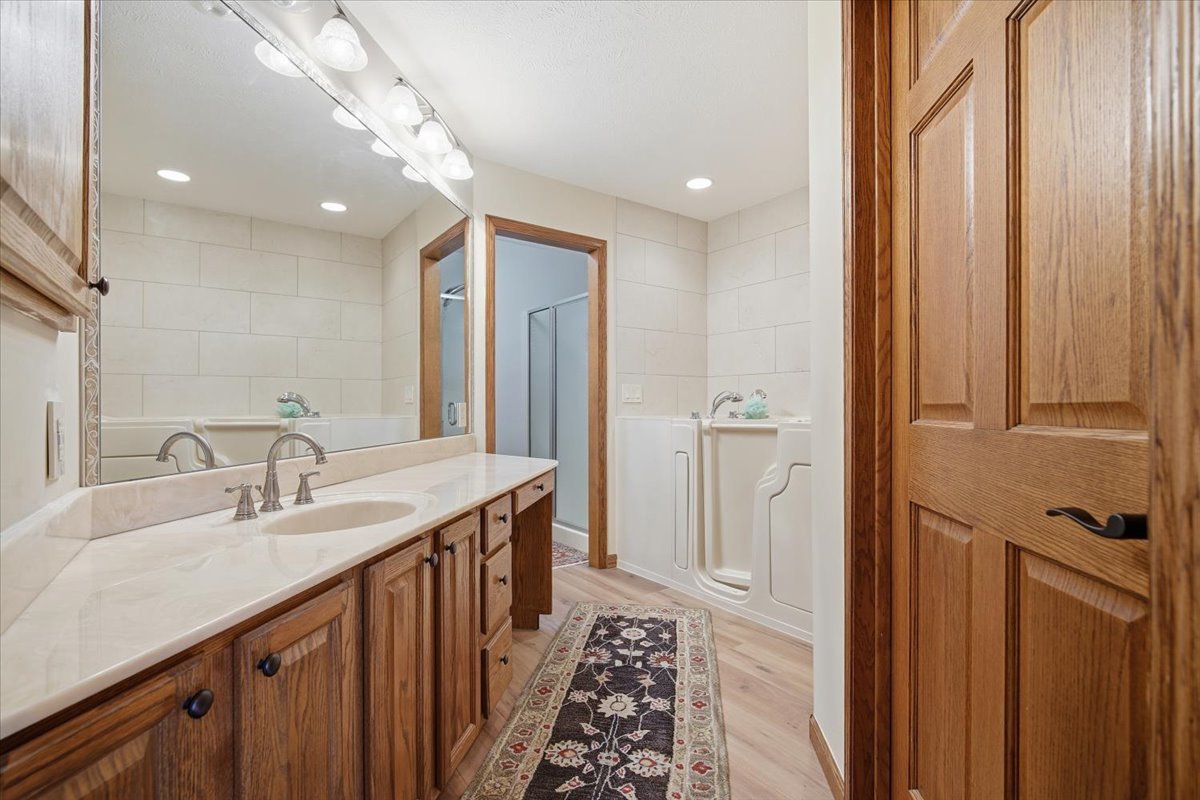 9 Spruce Court Bloomington, IL 61704 - Photo 20 of 42 a bathroom with a double vanity sink and a mirror