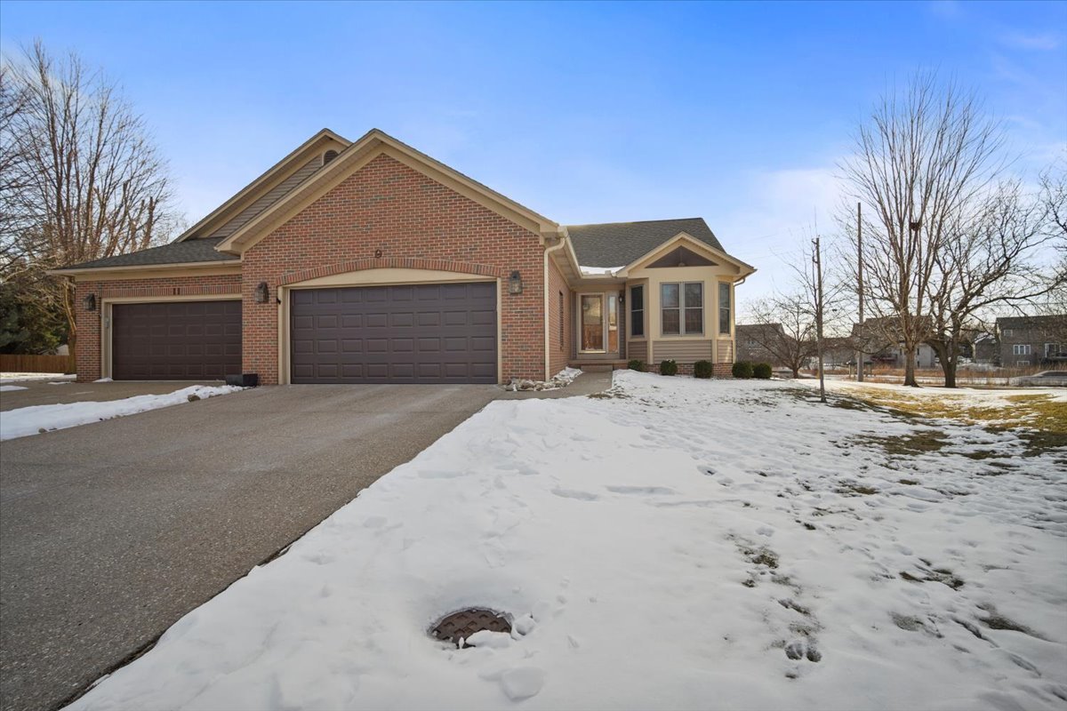 9 Spruce Court Bloomington, IL 61704 - Photo 2 of 42 a front view of a house with a yard covered with snow