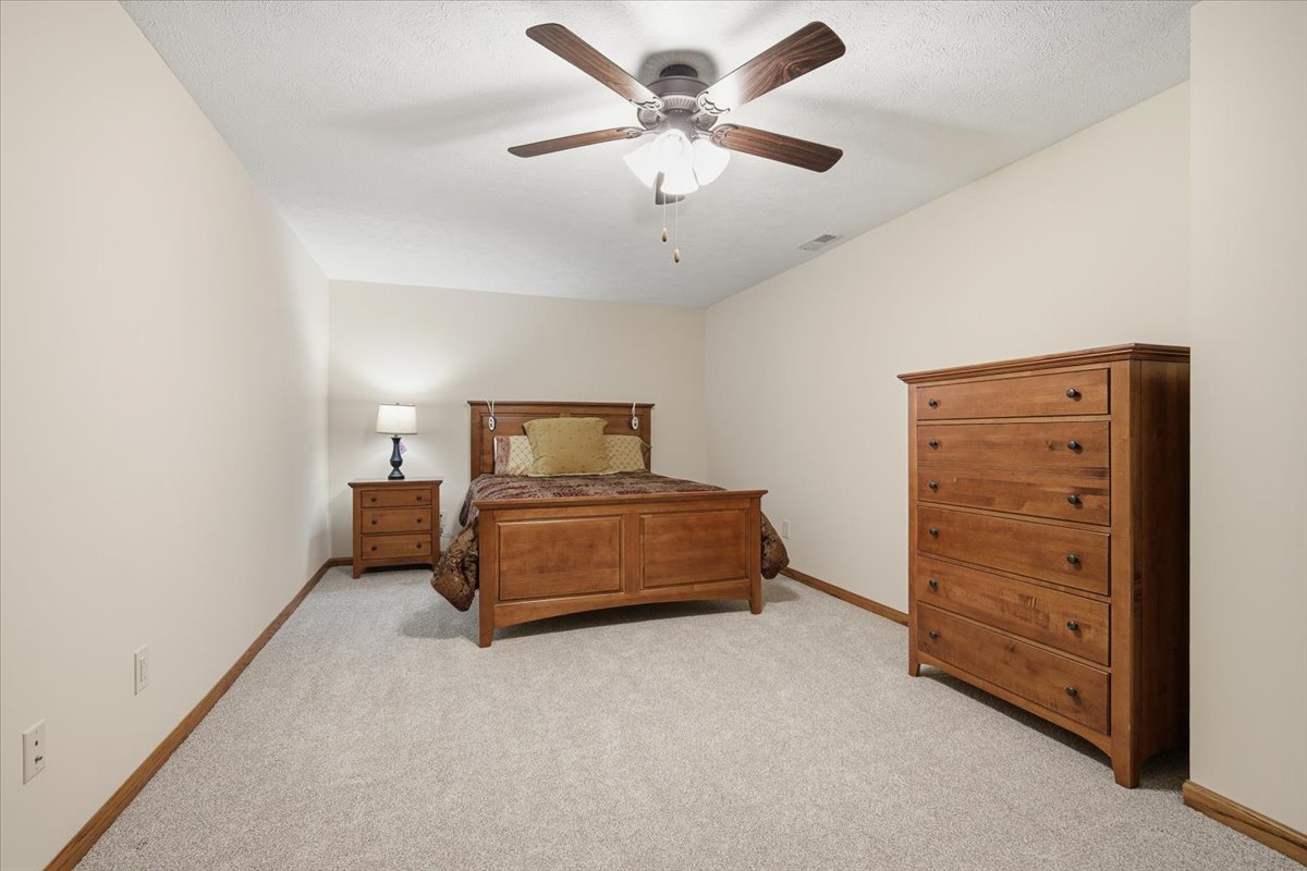 9 Spruce Court Bloomington, IL 61704 - Photo 30 of 42 a bedroom with a bed and a ceiling fan
