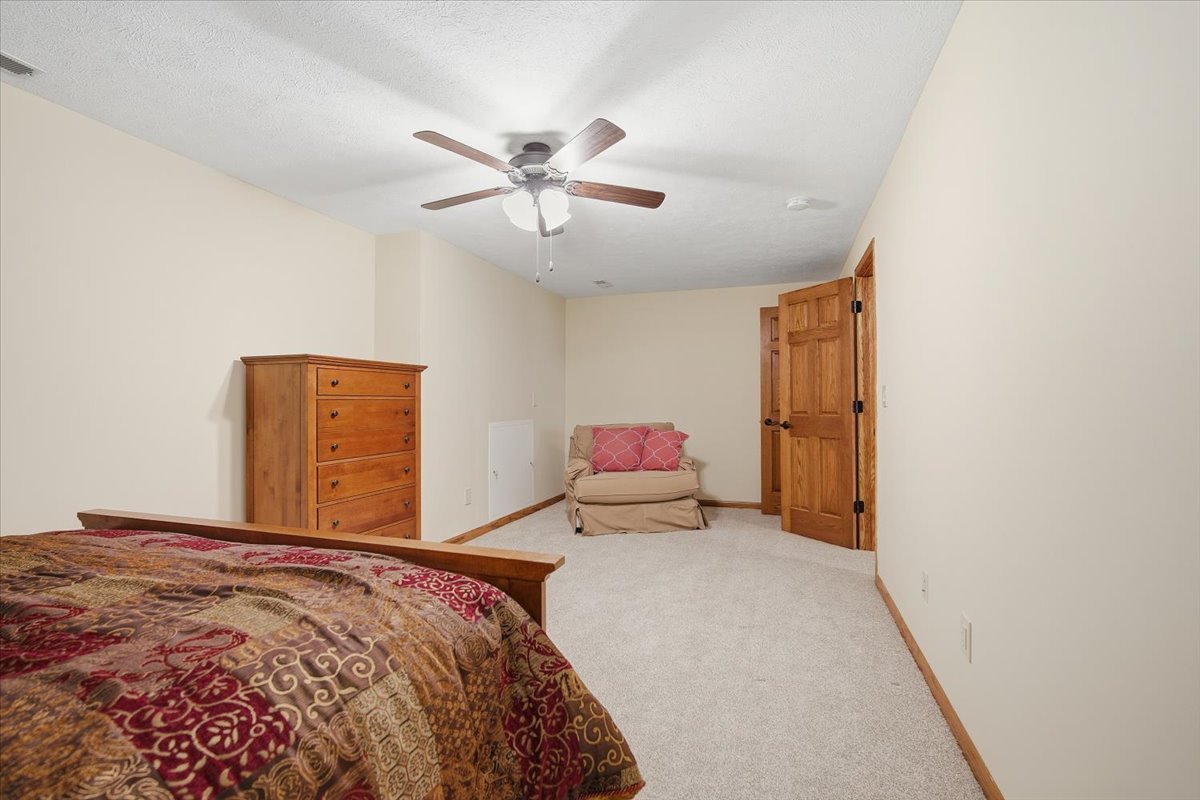 9 Spruce Court Bloomington, IL 61704 - Photo 31 of 42 a bedroom with a bed and a chandelier