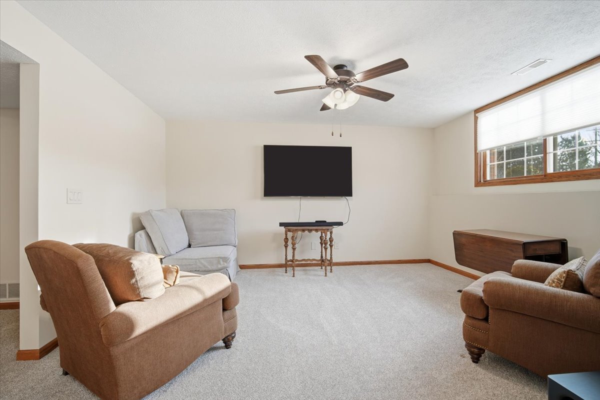 9 Spruce Court Bloomington, IL 61704 - Photo 32 of 42 a living room with furniture and a flat screen tv