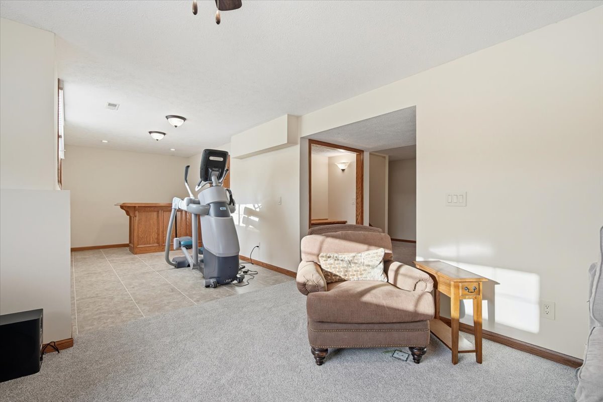 9 Spruce Court Bloomington, IL 61704 - Photo 33 of 42 a living room with furniture and gym equipment
