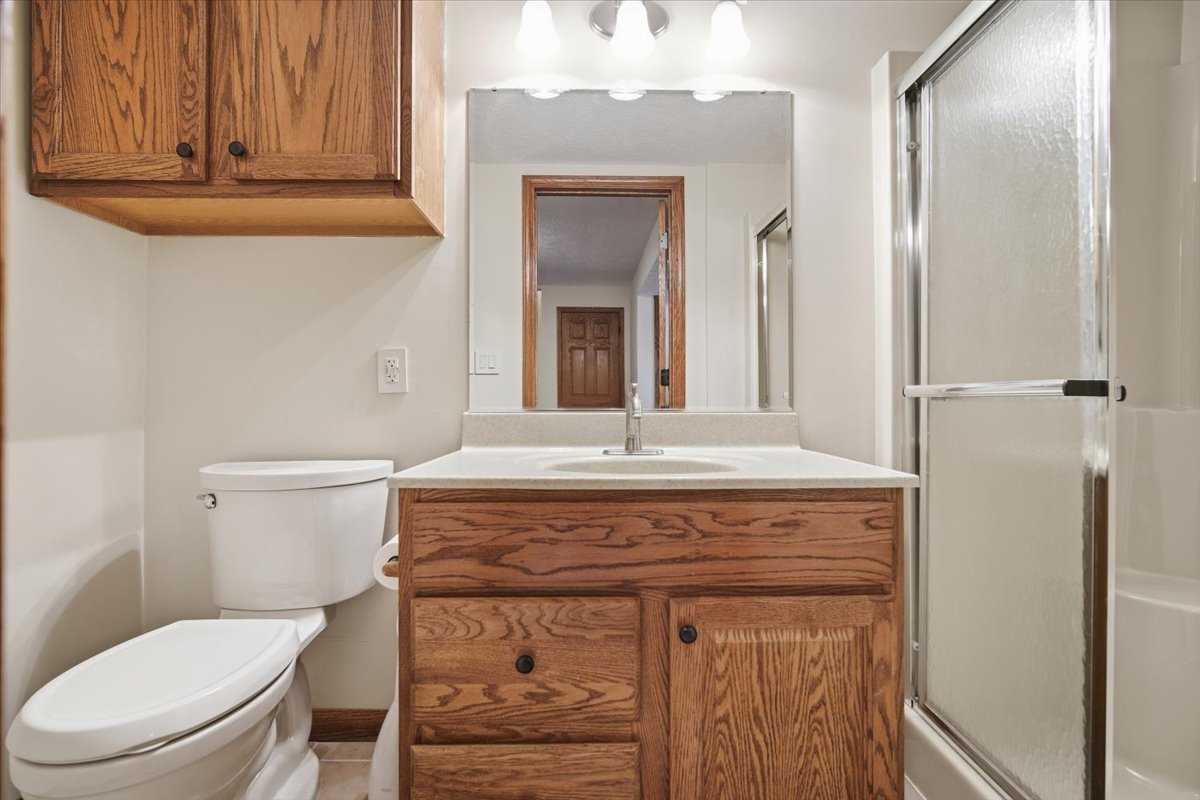 9 Spruce Court Bloomington, IL 61704 - Photo 37 of 42 a bathroom with a toilet a sink and mirror